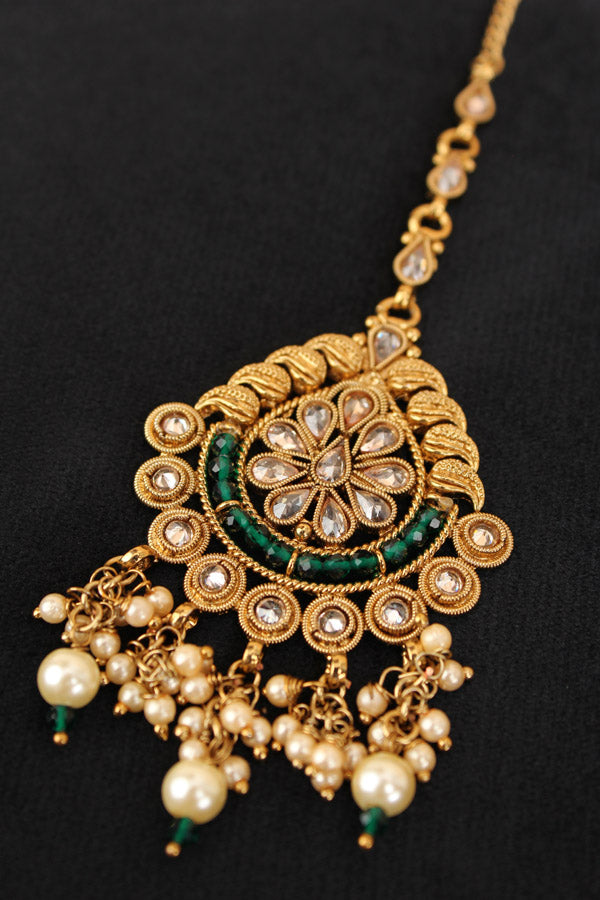 Tikka In Gold Polish With Reverse AD Stones And Green Crystal Beads (T010-G-Polki)