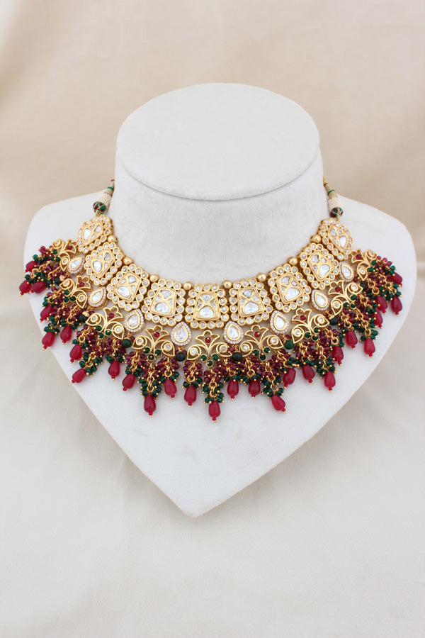 Kundan Necklace With American Diamonds And Red And Green Pearls With Earrings And Matching Tikka(NK003-G-K-B1)