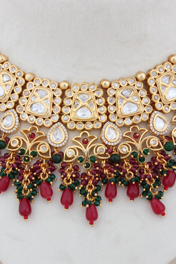 Kundan Necklace With American Diamonds And Red And Green Pearls With Earrings And Matching Tikka(NK003-G-K-B1)