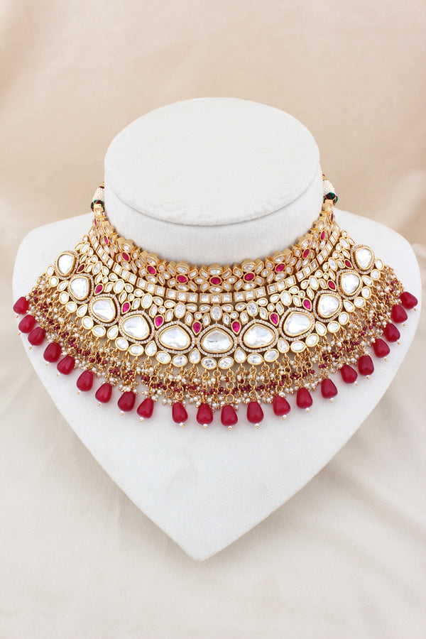 Necklace In Gold Polish With Kundan And Ruby Color Pearls Attached Also Large Earrings And Tikka(NK004-RU-K-B1)