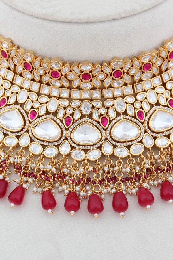 Necklace In Gold Polish With Kundan And Ruby Color Pearls Attached Also Large Earrings And Tikka(NK004-RU-K-B1)