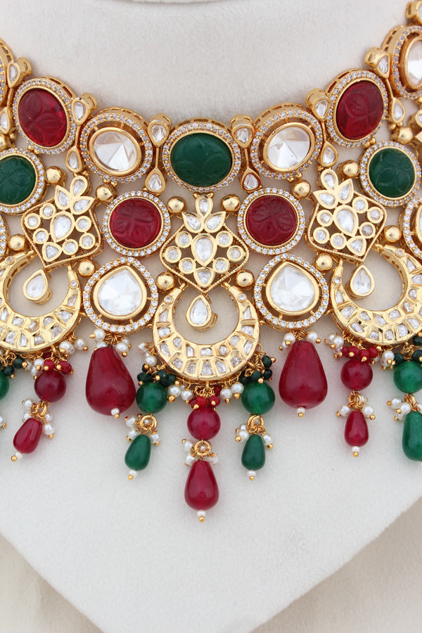 Premium Quality Kundan Set With American Diamonds And Red And Green Color Pearls Attached With Matching Earrings And Tikka(NK005-RG-K-B1)