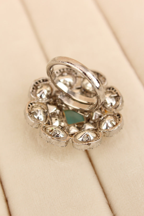 Silver Plated Quality Kundan Ring With Flower Design And Aqua Blue Colour Center Stone And Small American Diamonds (KR013-AB)